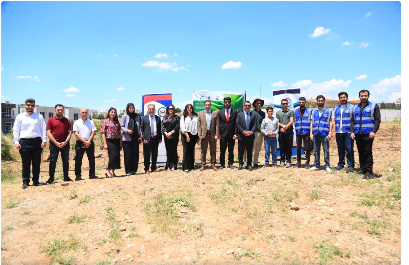 Group photograph of KIANO staff, volunteers and partners at the tree-planting site on the University of Duhok campus